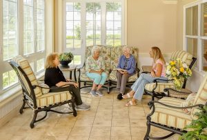image of residents and family chatting in the lobby at sunnyside manor senior living in wall nj